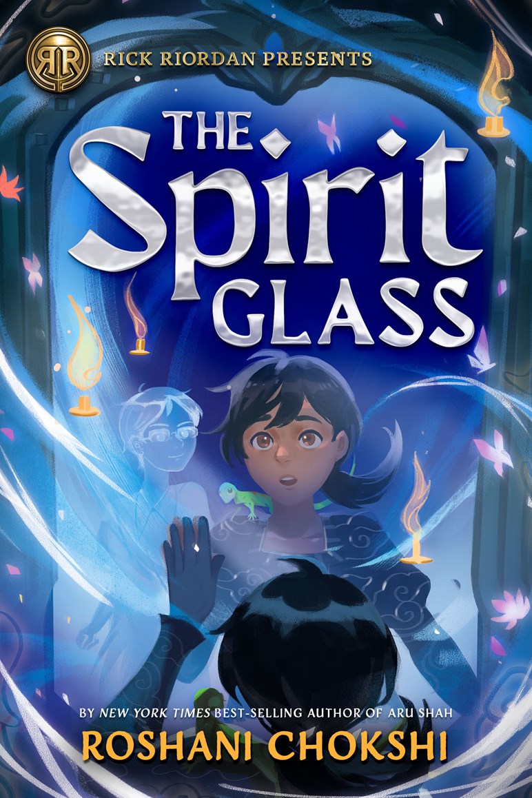 Book cover of 'The Spirit Glass' by Roshani Chokshi with a young dark haired girl looking into a mirror with a ghost inside, floating candles, and a blue and purple color scheme.